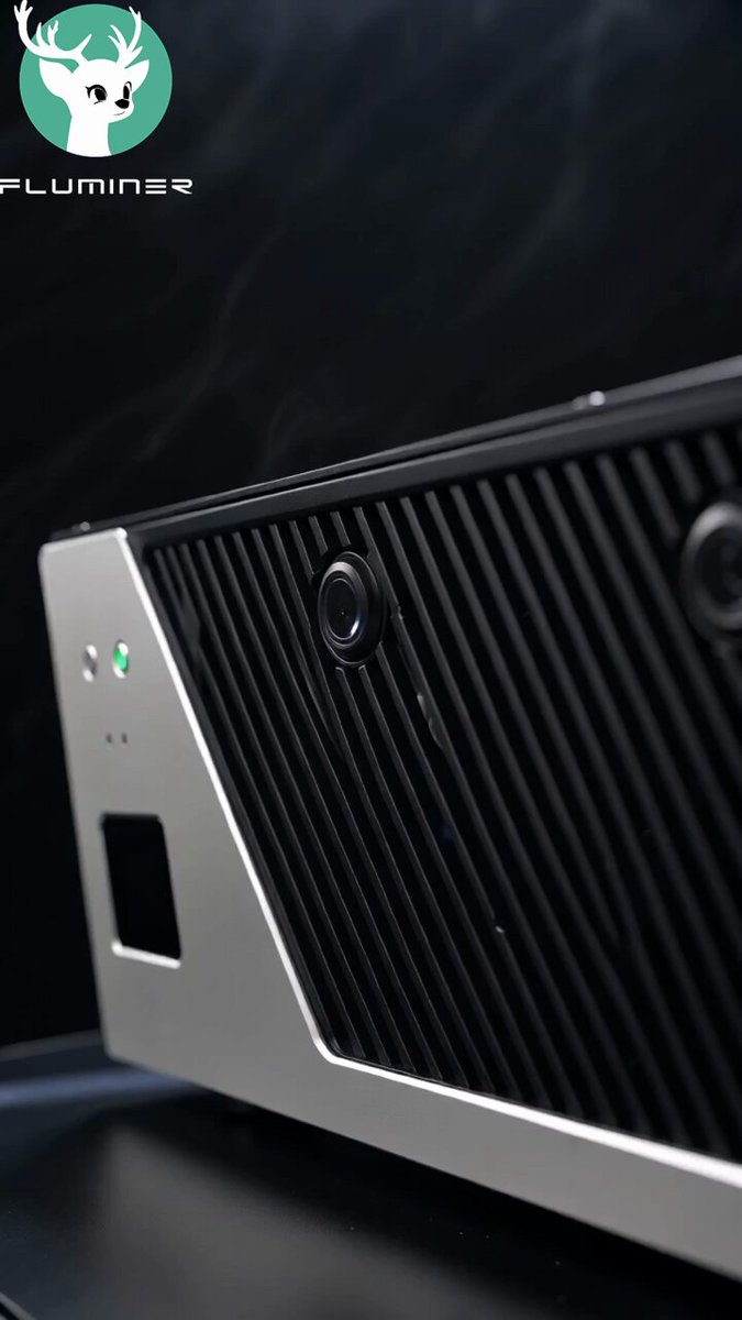 The image features a black and silver computer speaker, which appears to be a product of Fluminese. It has a unique design with a zigzag pattern on its surface. The speaker is placed against a dark background, making it stand out prominently in the photo. The caption below the image reads "The Quiet Bitcoin Miner Everyone Is Talking About", indicating that this particular speaker might have caught people's attention due to its distinctive appearance or features related to cryptocurrency mining.