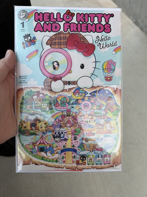 The image shows a packaged comic book titled "HELLO KITTY AND FRIENDS #1: Hello World," featuring Hello Kitty on the cover with a colorful amusement park illustration, aligned with the caption's playful affection for the $kitty theme.