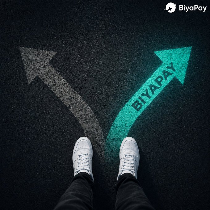 An advertisement for BiyaPay shows a person in white sneakers standing at a crossroads on asphalt, with a green arrow pointing forward labeled 'BIYAPAY' and a faded gray arrow pointing left.
