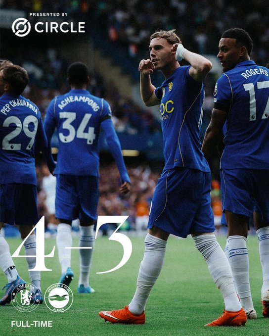 A Chelsea player cups his ear in celebration after their 4-3 full-time victory over Brighton, presented by Circle, with teammates wearing jerseys numbered 29 (Pepe/Inakiarría), 34 (Acheampong), and 17 (Rogers) visible in the background at Stamford Bridge.