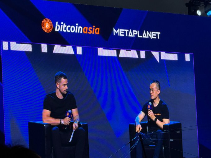 Two men seated on stage in conversation at the Bitcoin Asia conference, with the 'bitcoin asia' and 'METAPLANET' logos displayed on the screen behind them.