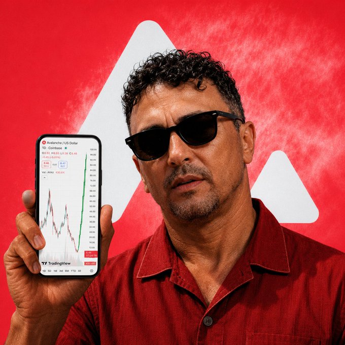 The image features a man wearing sunglasses and red shirt holding up his cell phone, which has an overlay of stock market graphs displayed on its screen. There are several other people present in the background, but they are blurred and not central to the main focus of the scene - the man and his cell phone showing off the stock charts. The image also includes a caption that references AVAX Involvement, which adds context to the visual content being displayed on the cell phone's screen.
