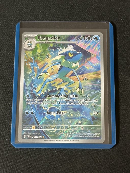 A holographic Pokémon trading card featuring Frogadier (Stage 1, evolves from Froakie, 100 HP) with the moves 'Summoning Jutsu' and 'Aqua Edge' (50 damage), displayed in a blue sleeve.
