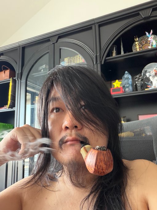 A shirtless man with long dark hair smokes a pipe while holding a crystal in his other hand, sitting in front of dark wooden cabinets displaying decorative items.

The image humorously embodies the post's theme of overcomplication—he appears to be performing an elaborate ritual instead of simply holding crypto assets like BTC, ETH, and OKB as advised, mocking the tendency to overthink investments when patience is all that's needed.