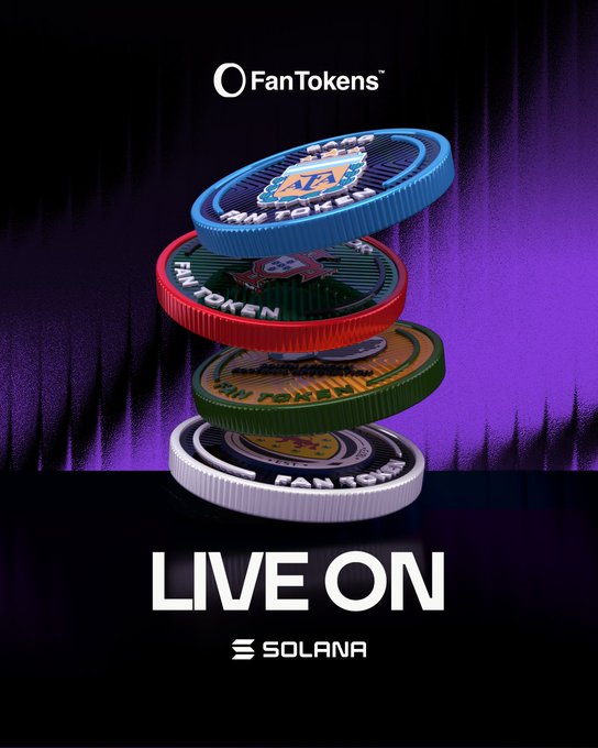The image features a stack of four different colored coins, each with unique designs, placed on top of one another. The text "Live On" is written above the coins, indicating that they are now live and available for trading or use. The coins are displayed against a black background, making them stand out prominently. The post also mentions Fan Tokens, which could be related to the coins' value or purpose in the context of the image.