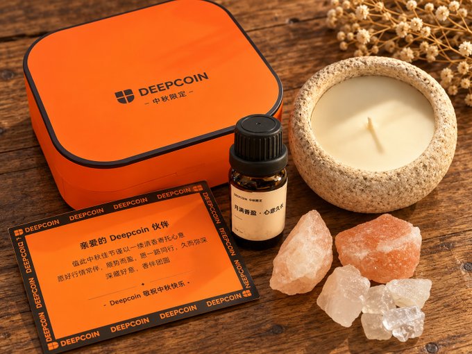 A product photo of a DEEPCOIN branded orange tin, a small bottle of essential oil, a candle, pink salt crystals, and an informational card