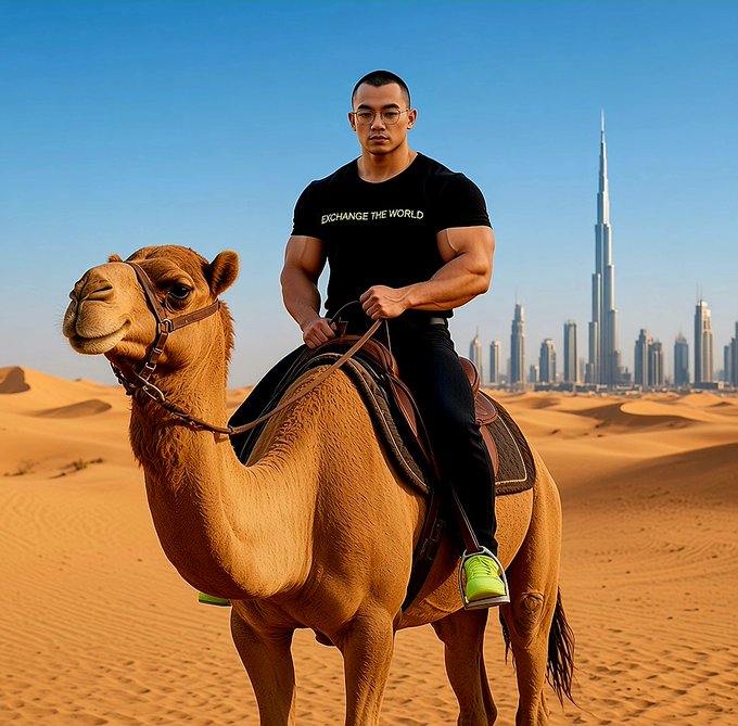 A digitally edited or AI-generated image of a muscular man in a black 'EXCHANGE THE WORLD' t-shirt riding a camel in the desert with the Dubai skyline, including the Burj Khalifa, in the background.