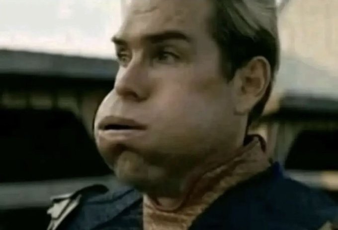Close-up still of Captain America/Steve Rogers (Chris Evans) with a surprised expression, wearing his costume.