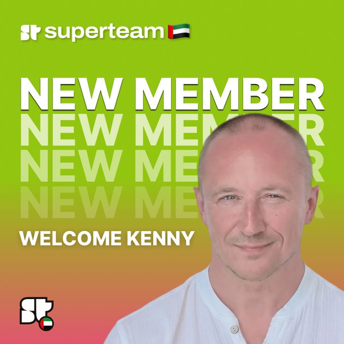 The image features a man wearing a white shirt with the words "Welcome Kenny" written below his face. The background of the image is green, which appears to be a part of an advertisement or promotional material for a new member feature on a website called @ShakenK3nny.