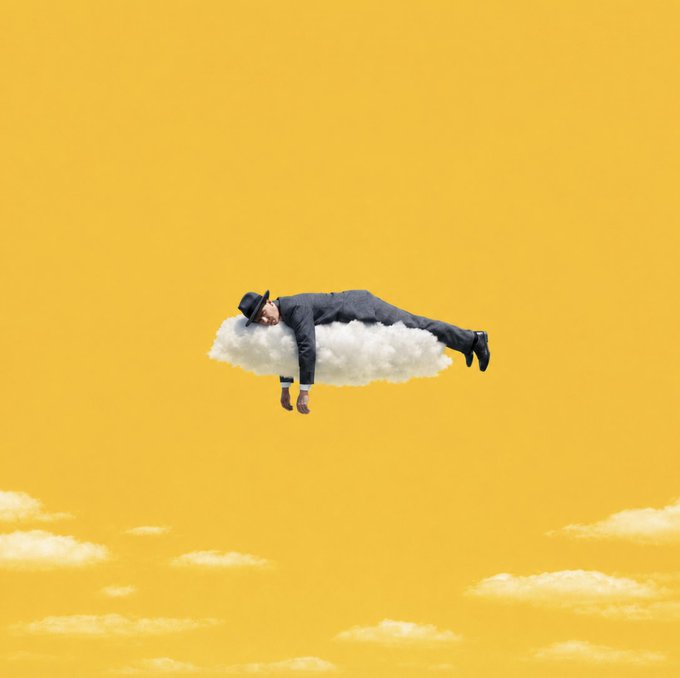 A man in a gray suit and fedora lies peacefully atop a small white cloud floating against a yellow sky, embodying the "GM" (Good Morning) post's message to slow down and embrace tranquility.