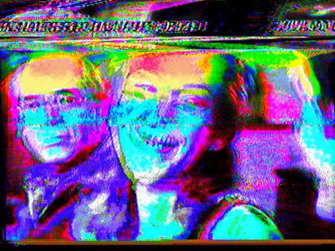 A heavily distorted, glitch-art style image showing three figures with vibrant neon pink, blue, and yellow color separation effects, with partially visible text reading 'BEAUTIFUL' at the top.