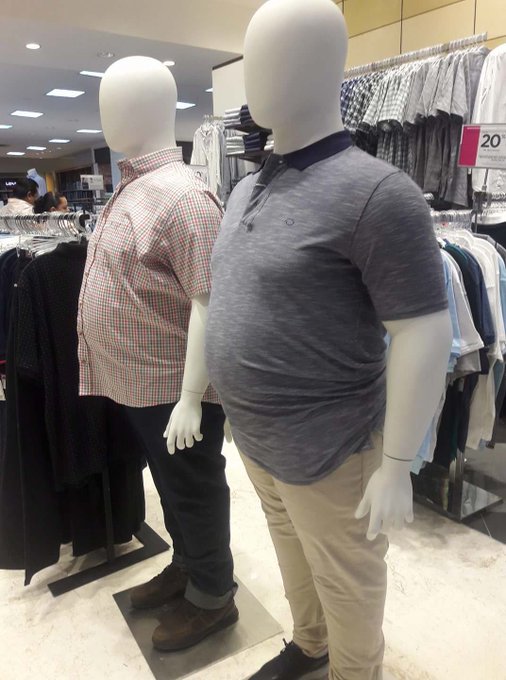 Two mannequins in a clothing store display men's apparel, with one notably wearing a tight polo shirt stretched over a noticeably protruding belly. The image humorously relates to the post by visually representing an "obvious bull-trap" — a misleading bullish signal — mirroring how the larger mannequin's confident appearance (a fitted polo) masks an unflattering truth, much like a bull trap disguises a downturn behind an upward trend. A "20% off" sale sign is visible in the background.