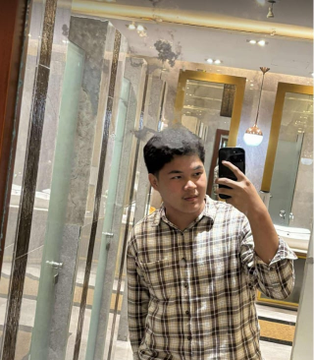 A young man in a plaid shirt takes a mirror selfie with his smartphone inside what appears to be a tile or marble showroom, captioned as "Me in our web3 guild" to contrast with being outside the web3 community.