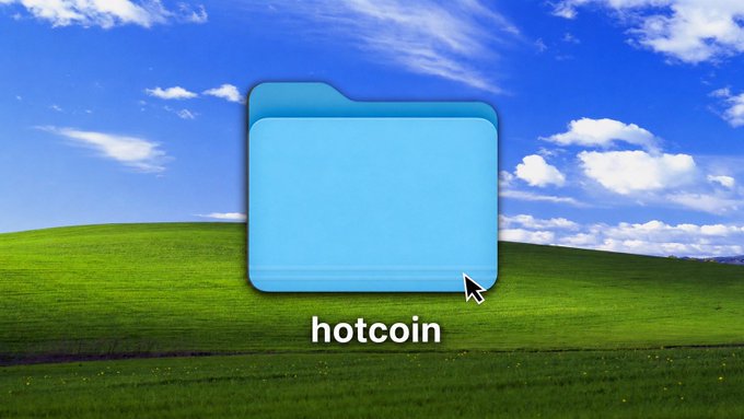 Classic Windows XP 'Bliss' wallpaper showing rolling green hills and blue sky, with a blue folder labeled 'hotcoin' and a cursor hovering over it.