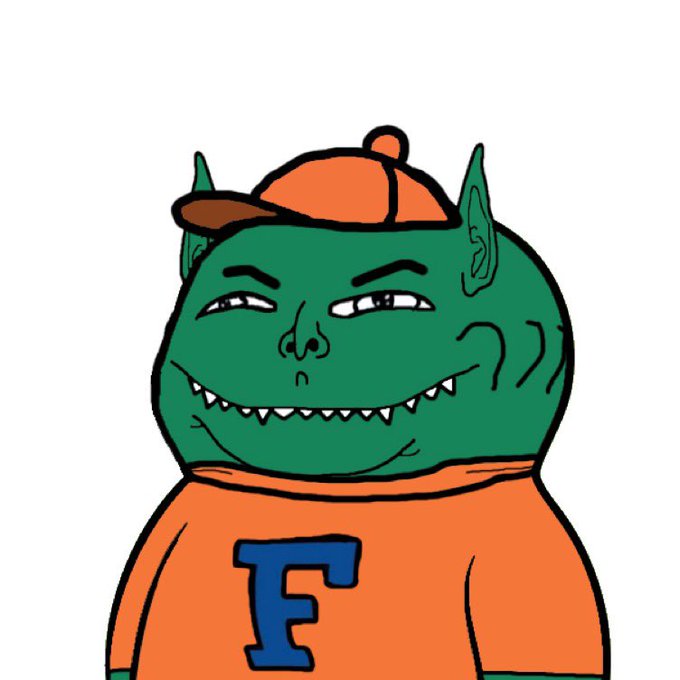 A cartoon drawing features a green-skinned goblin-like character with pointy ears, sharp teeth, and a sly expression, wearing an orange cap and an orange sweatshirt with a blue letter 'F' on it.
