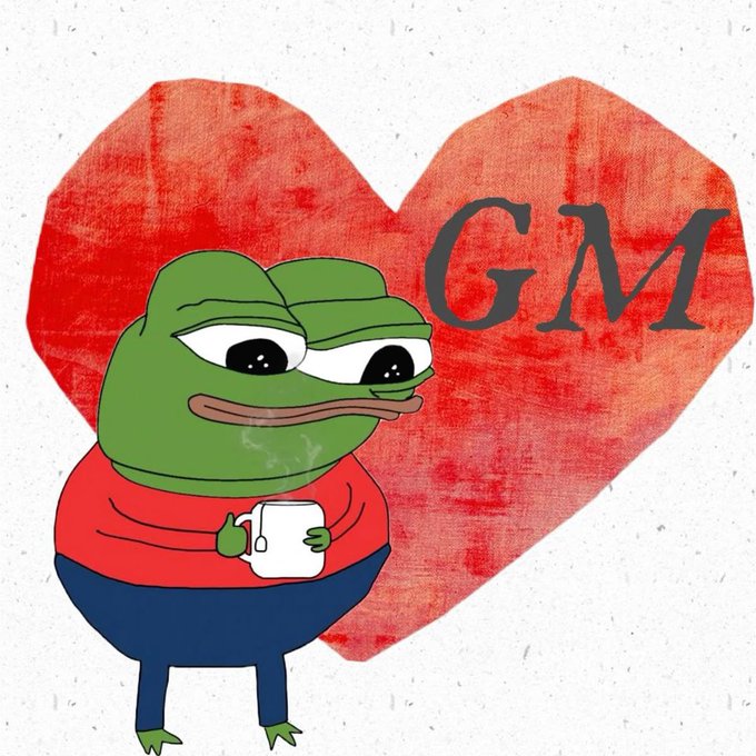 Pepe the Frog meme holding a mug in front of a red heart with "GM" written on it, representing the crypto good morning greeting.