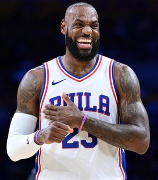 A smiling LeBron James, wearing a Philadelphia 76ers jersey with the number 23, claps his hands on the court after signing with the team—a move that has boosted the Sixers' 2027 NBA Finals odds from 8% to 13% on Polymarket.