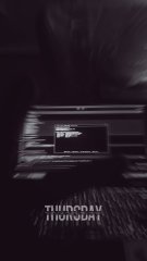 A dark, blurry black-and-white image showing what appears to be a monitor or screen with the text 'THURSDAY THROW' visible at the bottom.