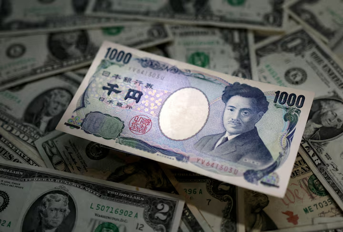 A Japanese 1,000 yen banknote featuring the portrait of Natsume Soseki rests on top of a scattered pile of US dollar bills. The image illustrates a currency exchange or forex comparison between yen and dollars.
