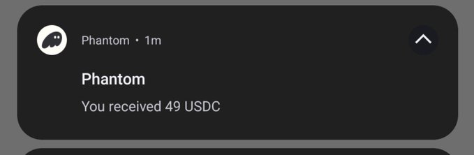 A screenshot of a Phantom wallet notification showing "You received 49 USDC" from the Phantom sender, supporting the post celebrating a $50 receipt.