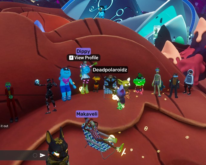 A screenshot from a VR/social game (likely Rec Room) showing multiple colorful avatars including ones labeled 'Dippy', 'Deadpolaroidz', and 'Makaveli' on a reddish terrain with a game menu visible.