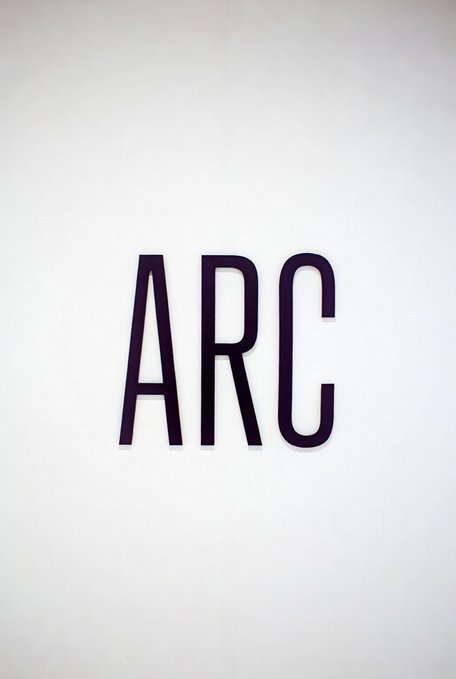Minimalist image showing the letters 'ARC' in dark serif font centered on a plain white background.