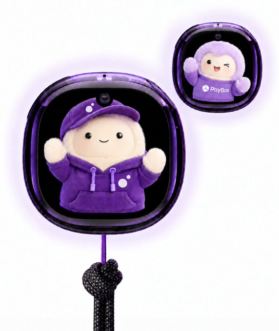 A purple, cube-shaped device features an adorable mascot character wearing a purple hoodie, with a smaller version showing the same character alongside the "PlayBox" logo. The pair of mascots, one waving cheerfully with both hands raised, perfectly embodies the "charming duo" described in the post.