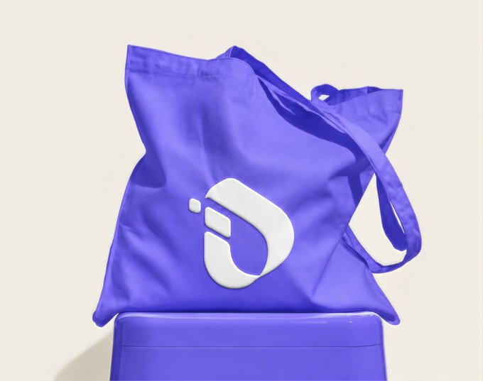 A vibrant purple tote bag featuring a stylized white logo rests on a matching purple pedestal, presented as a branded giveaway. The promotional post suggests it's a special gift celebrating a 10M milestone for their "Linkers" community, with hashtags #InterLink, #ITLG, and #ITL tying the merchandise to the company's branding and audience.