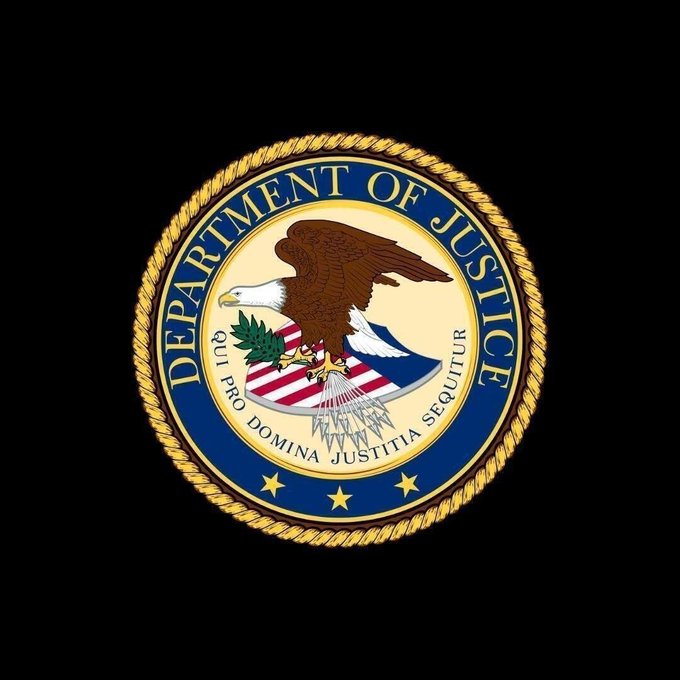 The official seal of the **Department of Justice** is displayed, featuring a bald eagle clutching arrows and an olive branch above a red-and-white striped shield, encircled by a gold rope border and the Latin motto *"Qui Pro Domina Justitia Sequitur."* The seal represents the DOJ, the federal agency that charged NFT startup founder Taj Tarsha with allegedly stealing over $10M in $FAR token presale funds to finance his lavish lifestyle and online gambling.