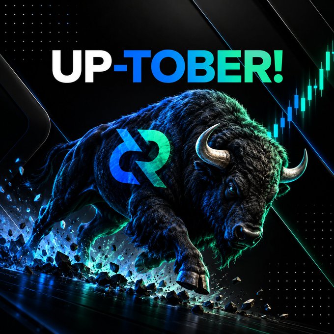 A promotional graphic reading 'UP-TOBER!' featuring a charging black bull with a logo on its side, set against a dark background with green and blue financial chart elements.