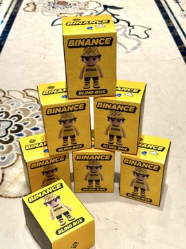 The image features a collection of six binancezh trading cards neatly stacked together on top of each other. The cards are yellow with black text that reads "binANCEH" and "BLIND BOX", indicating they are trading cards for the game Binanceh. The cards are arranged in two rows, with three cards in each row. The cards appear to be in good condition, suggesting they have been well-cared for or perhaps even collected by their owner.