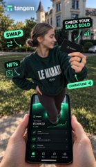 An advertisement for Tangem wallet shows a woman holding a phone displaying the app interface, with text overlays reading 'tangem', 'SWAP', 'CHECK YOUR WALLET SCORE', 'NFTS', and 'OPERATIONS'.