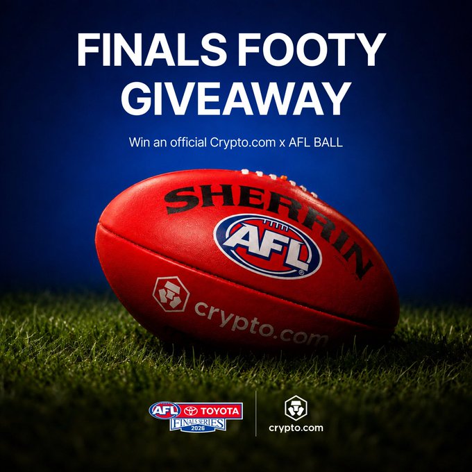 A red Sherrin AFL football branded with "crypto.com" and the AFL logo rests on grass beneath bold "FINALS FOOTY GIVEAWAY" text, promoting a contest to win this official Crypto.com x AFL ball tied to the Toyota AFL Finals Series 2026 and the Grand Final week celebration.