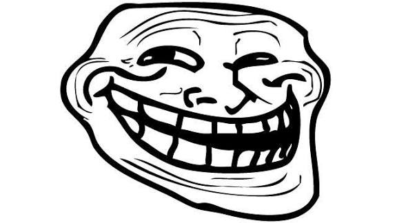 A black and white line drawing of the classic troll face meme, featuring a wide, exaggerated grin with prominent teeth.