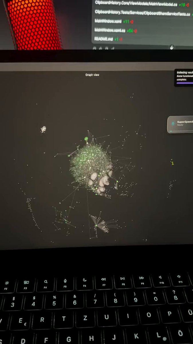 The image shows an open laptop screen displaying a computer game with a large map of green squares and white lines. The game appears to be a maze or puzzle that requires players to navigate through various locations within the map. The laptop's keyboard can be seen in front of the screen, indicating that it is actively being used by someone playing the game.