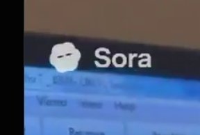 A photograph of a computer screen displaying the Sora logo (a white cloud-like icon) next to the word 'Sora' against a black bar at the top of a webpage interface.