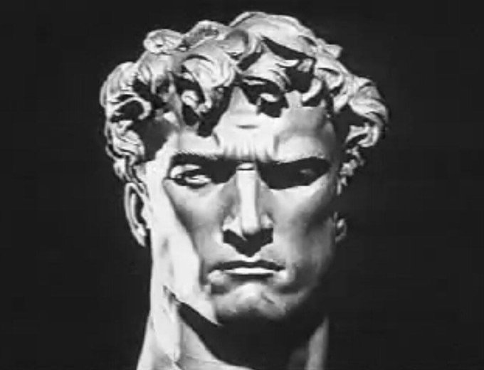 A black and white image of a stern, classical marble bust statue with an intense, disappointed expression. The post suggests the sender was scammed out of $10, with the statue's judgmental glare humorously embodying their disapproval of the rug pull.