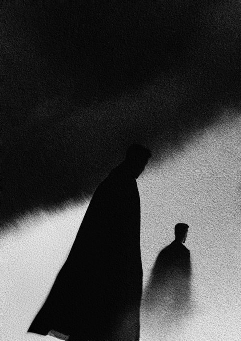 A high-contrast, grainy black-and-white image shows a large shadowy figure looming over a smaller person in a foggy void.