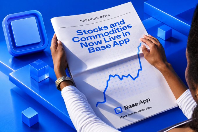 Breaking news announcement reading 'Stocks and Commodities Now Live in Base App' with the Base App logo and tagline 'More assets, same app.' shown on a newspaper held over a blue background with cubes.