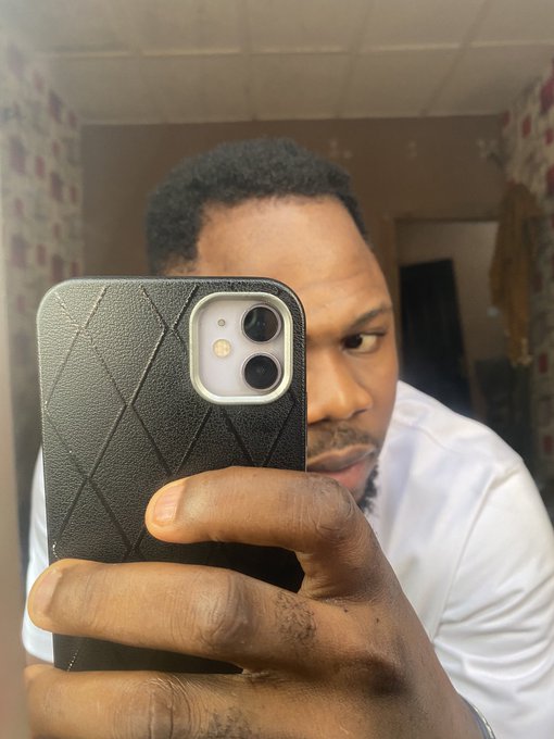 A man takes a mirror selfie with a black quilted iPhone case, partially obscuring his face as he looks at the camera. The image appears to be a casual greeting, fitting with the "Hello CTNG" caption as a personal introduction to followers.