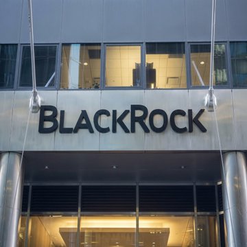 The exterior entrance of a BlackRock office building, featuring the company's name prominently displayed on the metallic facade.