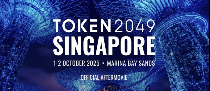 Promotional graphic for "TOKEN 2049 SINGAPORE" official aftermovie, taking place 1-2 October 2025 at Marina Bay Sands, featuring the illuminated Supertree Grove against a dark blue background.