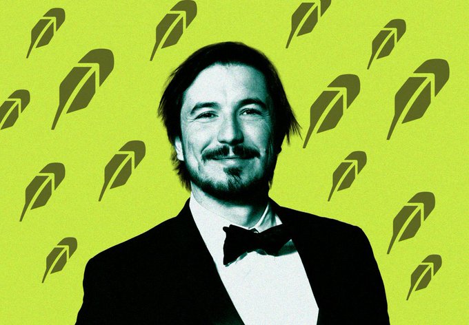 A stylized image of Keanu Reeves in a tuxedo smiling against a lime green background patterned with falling leaf silhouettes.