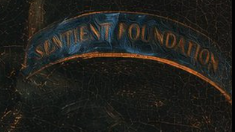 A close-up of a dark leather patch or banner with gold-embroidered text reading 'SENTIENT FOUNDATION'.