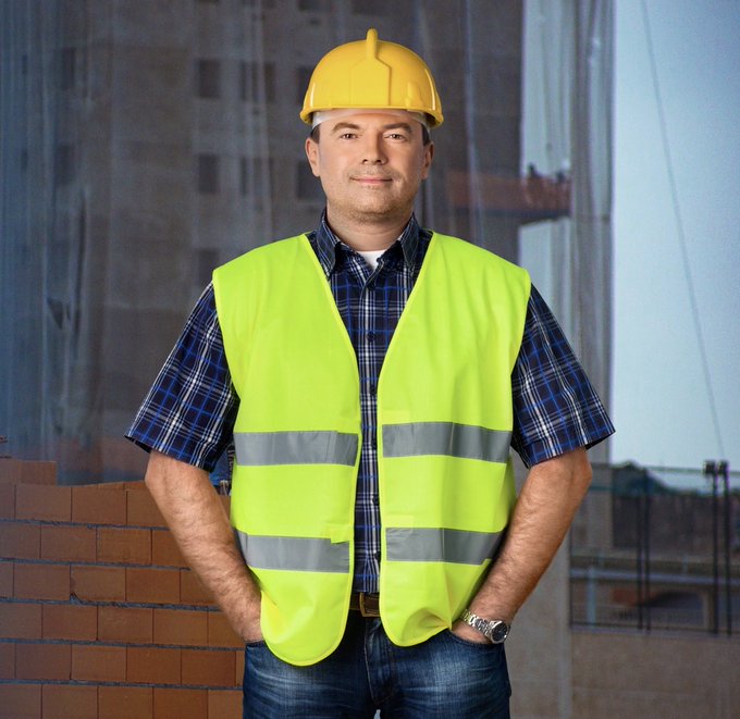 A construction worker in a yellow hard hat and neon safety vest stands confidently in front of a building under construction, smiling at the camera. The image humorously illustrates the message, showing Steven that he better gear up quickly and get to work, leaving his raccoon crypto ventures behind.