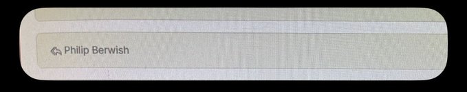 A close-up of a label or name tag reading "Philip Berwish" with a small house icon, set against a textured beige background.