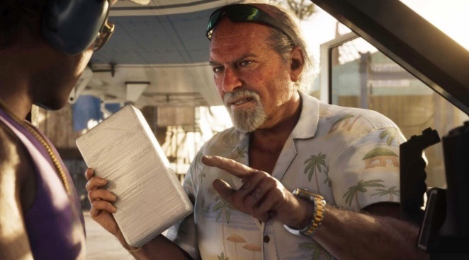 A bearded man in a tropical Hawaiian shirt and sunglasses on his head intently points at a notebook held by another person. The image relates to the post by possibly depicting a GTA 6 leaker discussing information, tying into the article about leakers promoting memecoins while claiming to act for gamers' rights.