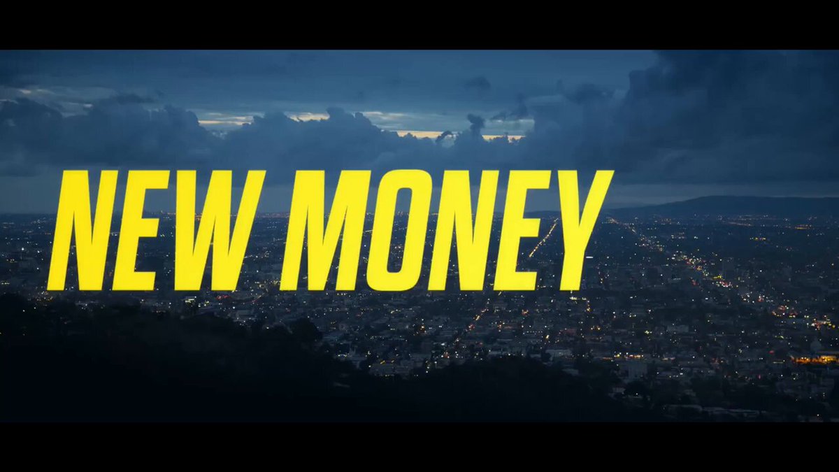 The image features a cityscape with buildings lit up at night, creating a vibrant urban atmosphere. In the foreground of the image, there's a banner that reads "New Money" written in yellow letters against a black background. The text stands out prominently due to its bright color and size. The phrase "Dogecoin" is also present on the banner, which adds an element of humor or lightheartedness to the scene.