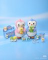 Small plush toys, including a penguin and what appears to be Hello Kitty characters, are arranged on a light blue surface with the text 'SUBIN' visible.