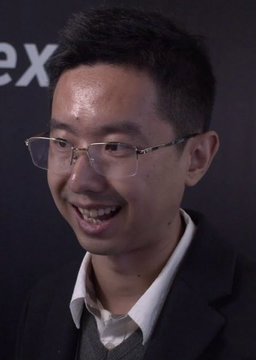 A smiling man with short black hair and glasses is shown in what appears to be an interview setting, with partial text "ex" visible behind him, possibly suggesting a Zcash (ZEC) related context that aligns with the post discussing ZEC holdings and liquidation.